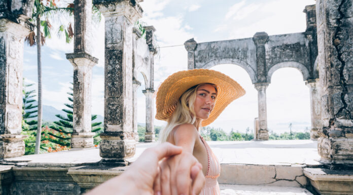 Bali Remains Safe to Visit Despite Being in a Disaster Alert Status Young woman in Taman Ujung water palace, Bali island, Indonesia (photo: envato elements)
